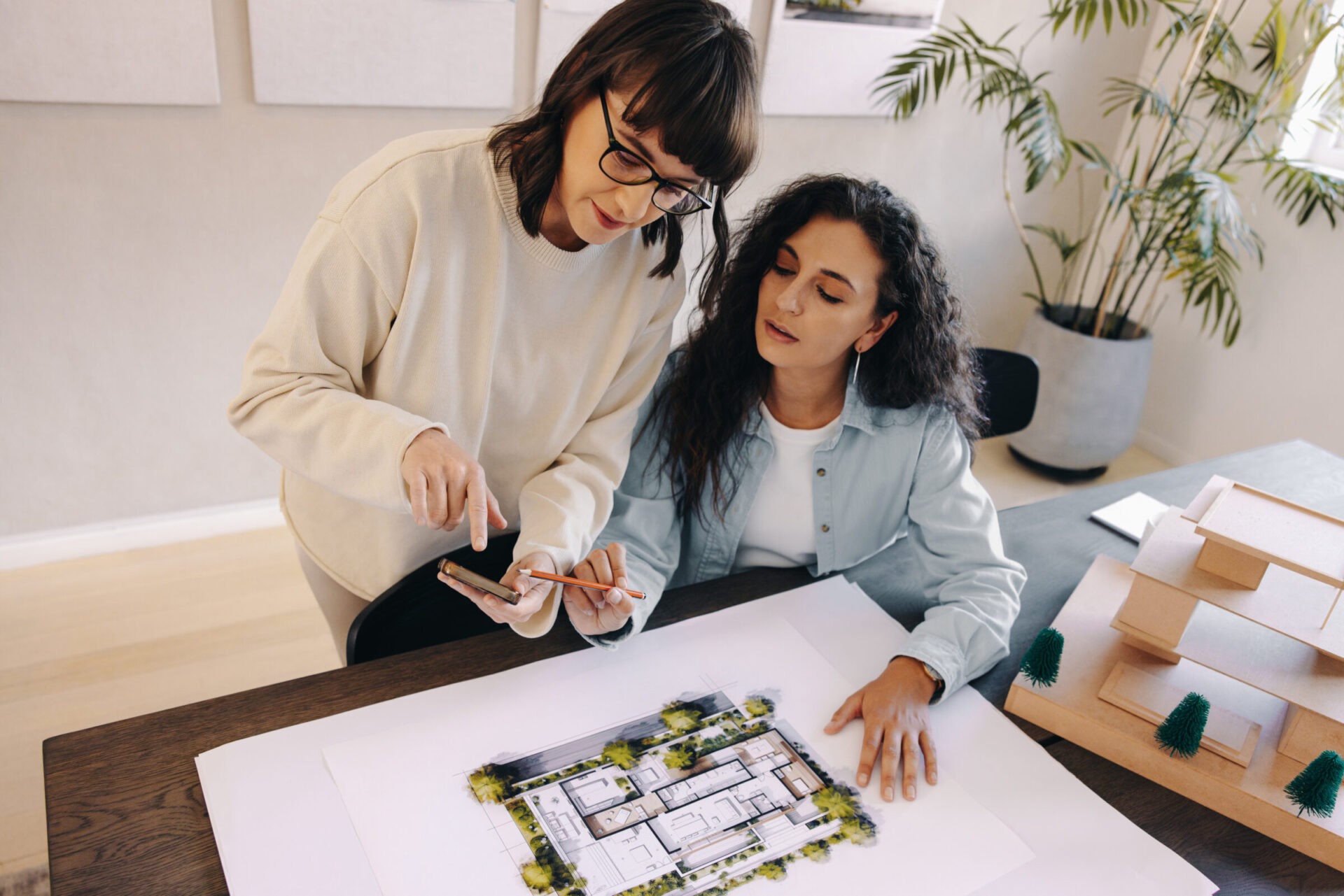 Two women plan out the landscape design in Windsor, ON.